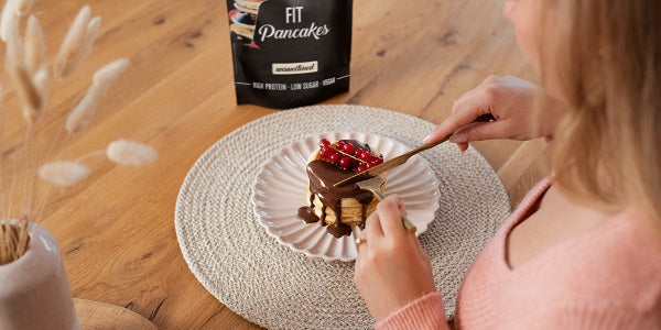 Person schneidet nu3 Fit Pancakes an