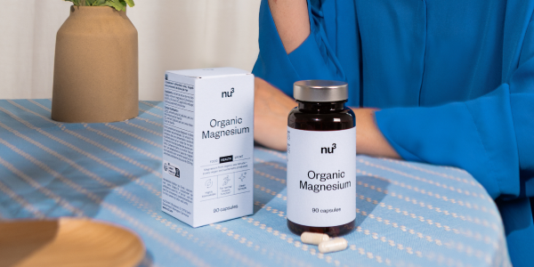Magnesium Dose und Verpackung auf Tisch mit blauer Decke
