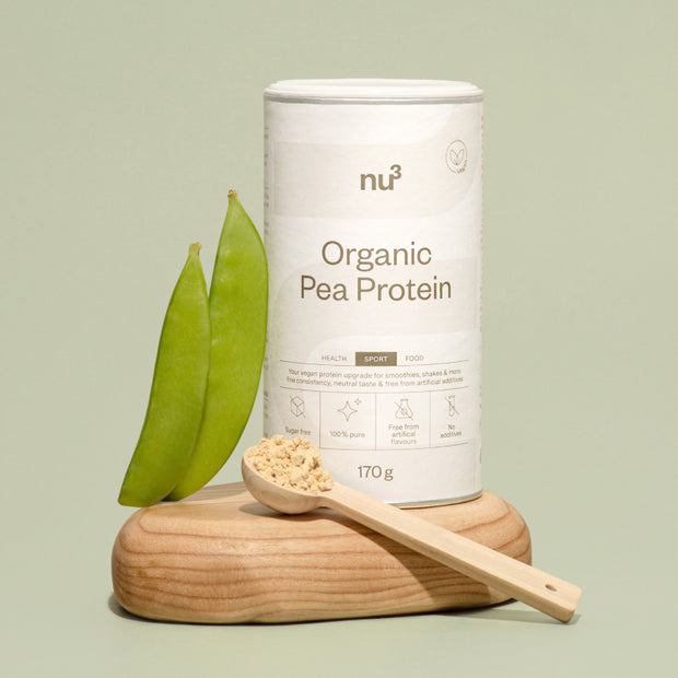 nu3 Bio Erbsenprotein neben Pulver auf Holzlöffel